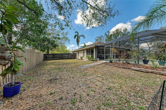 1127 133rd St E, Bradenton, FL 34212 - view of yard featuring a fenced backyard and glass enclosure