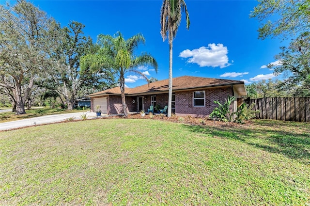 1127 133rd St E, Bradenton, FL 34212 - single story home with driveway, a front yard, fence, brick siding, and a garage