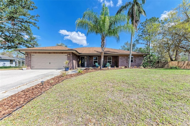 1127 133rd St E, Bradenton, FL 34212 - ranch-style house featuring fence, a garage, a front yard, brick siding, and driveway