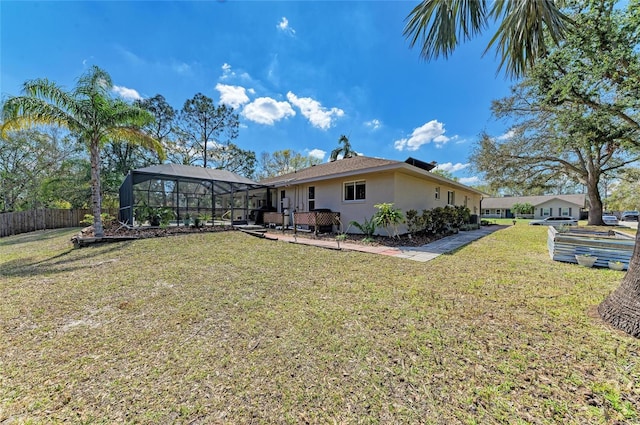 1127 133rd St E, Bradenton, FL 34212 - back of property featuring stucco siding, fence, a lanai, and a yard