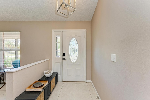 1127 133rd St E, Bradenton, FL 34212 - foyer entrance with light tile patterned floors, baseboards, and a textured ceiling