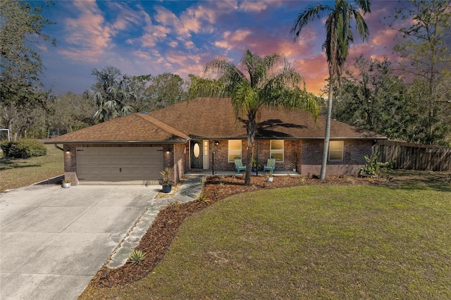 1127 133rd St E, Bradenton, FL 34212 - ranch-style home with a front yard, an attached garage, brick siding, and concrete driveway