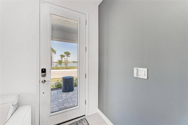 entryway featuring baseboards