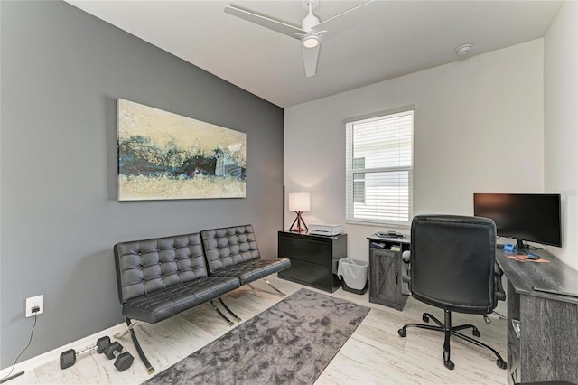 home office featuring a ceiling fan, wood finished floors, and baseboards