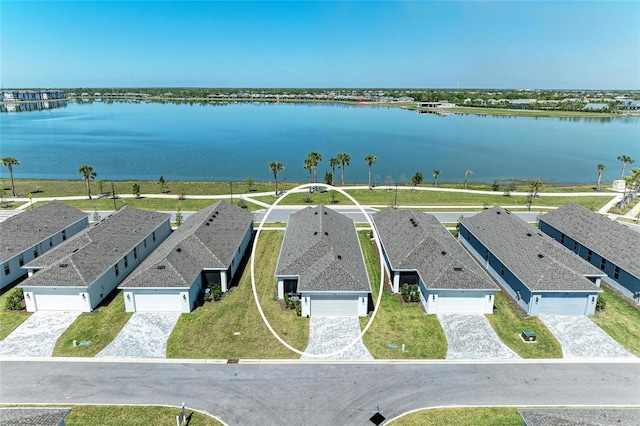 drone / aerial view with a residential view and a water view