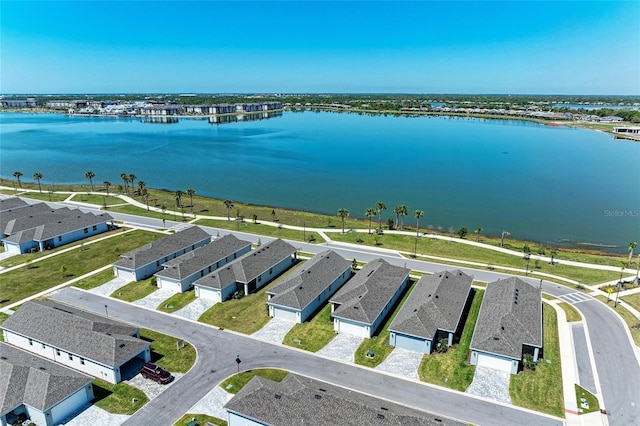 birds eye view of property with a residential view and a water view