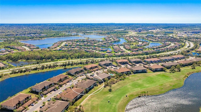 drone / aerial view with a residential view and a water view