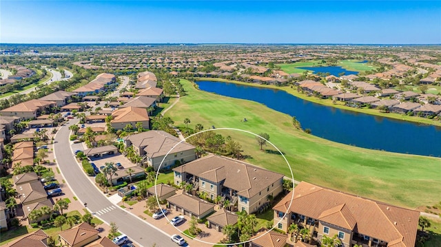 aerial view of residential area with a large body of water and a local golf course