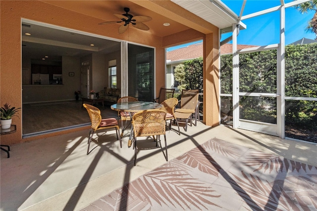 sunroom featuring ceiling fan