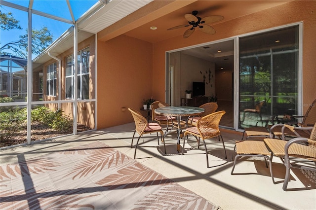 sunroom featuring a ceiling fan