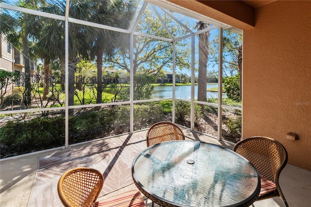 sunroom / solarium featuring a water view