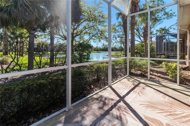 unfurnished sunroom featuring a water view