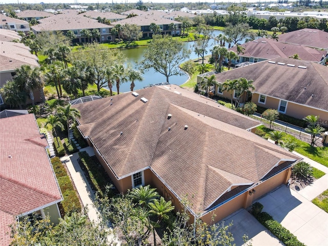 drone / aerial view featuring a residential view and a water view