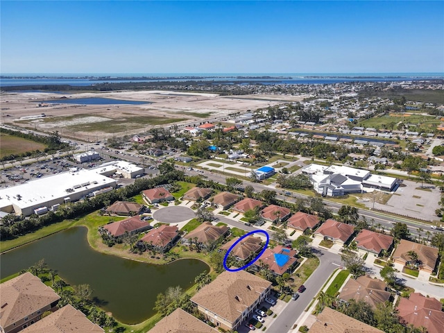 birds eye view of property with a residential view and a water view