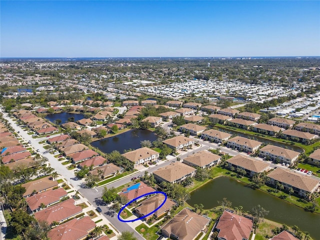 birds eye view of property with a residential view and a water view