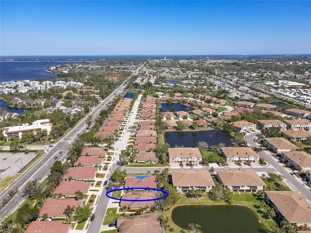 birds eye view of property featuring a residential view and a water view