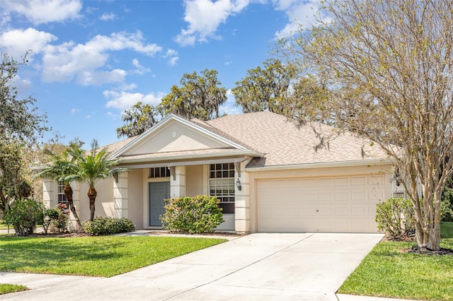 view of front of home featuring a shingled roof, a front lawn, concrete driveway, stucco siding, and a garage