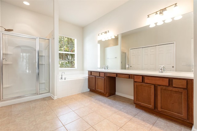 full bath featuring double vanity, a shower stall, a garden tub, and a sink