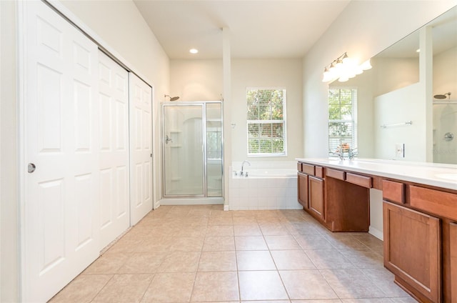 bathroom with tile patterned floors, a garden tub, double vanity, and a shower stall