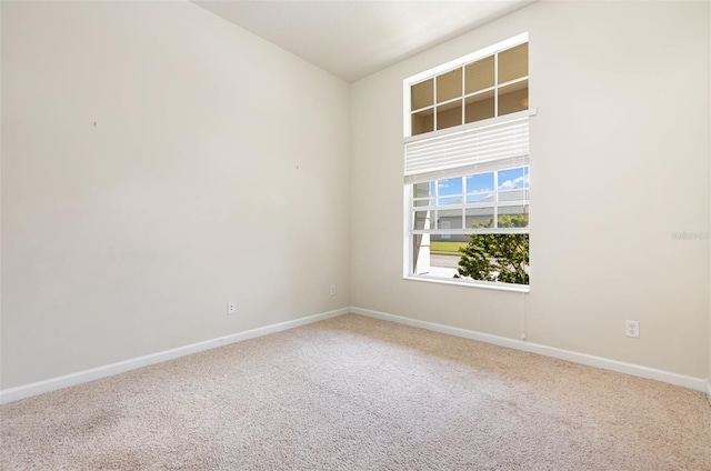 carpeted empty room with baseboards