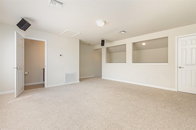 empty room featuring visible vents, baseboards, and carpet