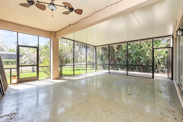 unfurnished sunroom featuring a ceiling fan