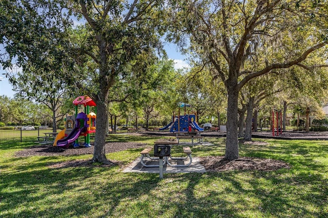 community playground with a yard and fence