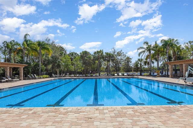 community pool featuring a patio area, fence, and a pergola