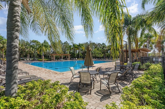 pool featuring a pergola, a patio, and fence