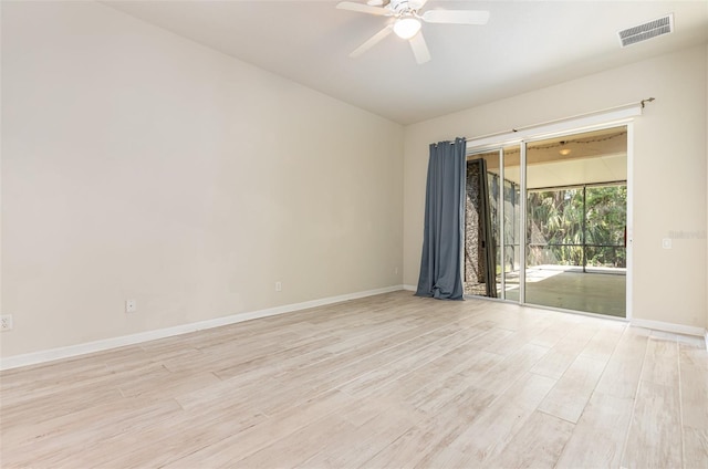 unfurnished room with baseboards, a ceiling fan, visible vents, and light wood-type flooring