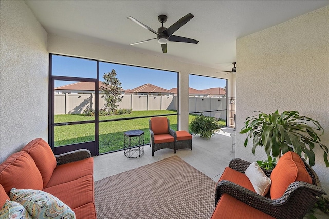 sunroom / solarium featuring ceiling fan