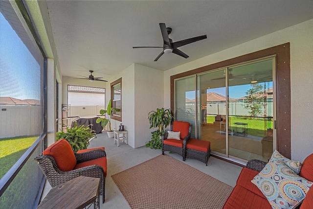 sunroom / solarium with a ceiling fan