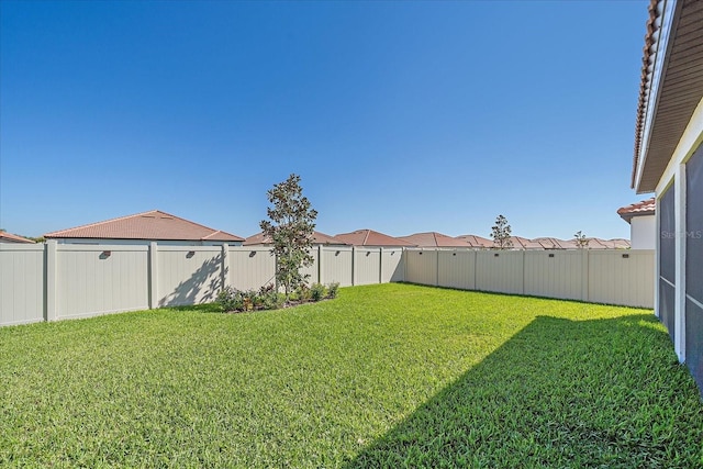 view of yard with a fenced backyard