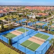 view of sport court featuring a tennis court and fence