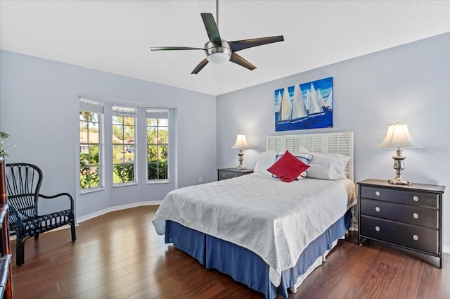 bedroom with ceiling fan, baseboards, and wood finished floors