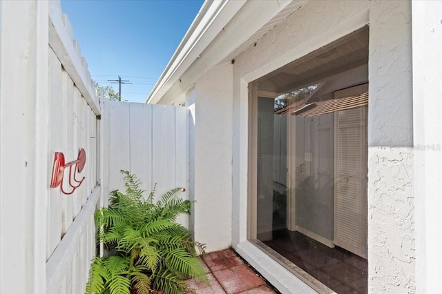 view of exterior entry with stucco siding