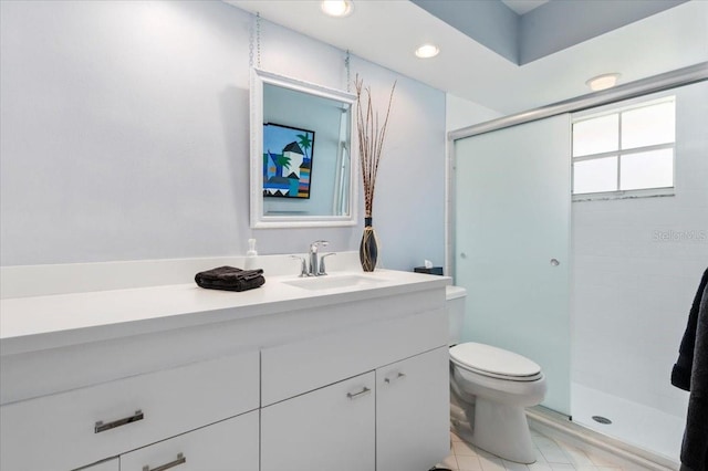 bathroom featuring recessed lighting, toilet, a stall shower, and vanity