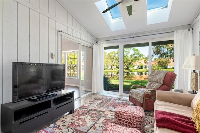 sunroom / solarium with lofted ceiling with skylight and ceiling fan