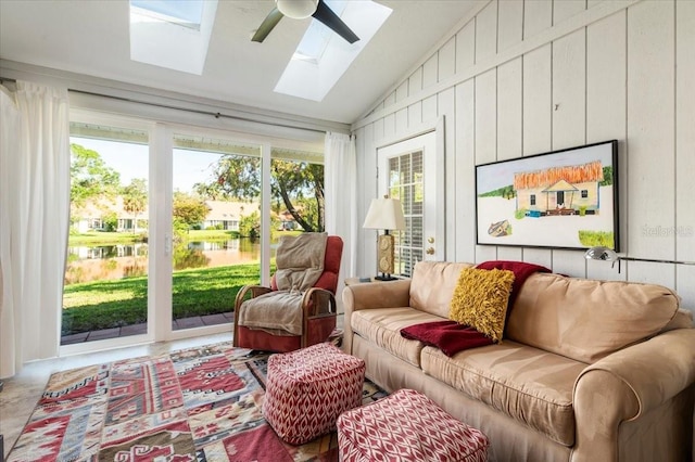 sunroom featuring vaulted ceiling with skylight and a ceiling fan