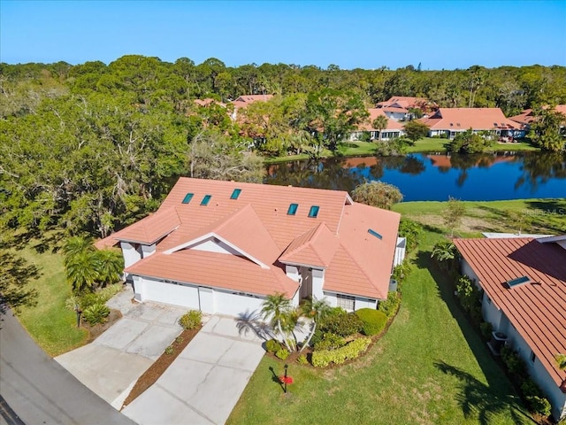 bird's eye view with a wooded view and a water view