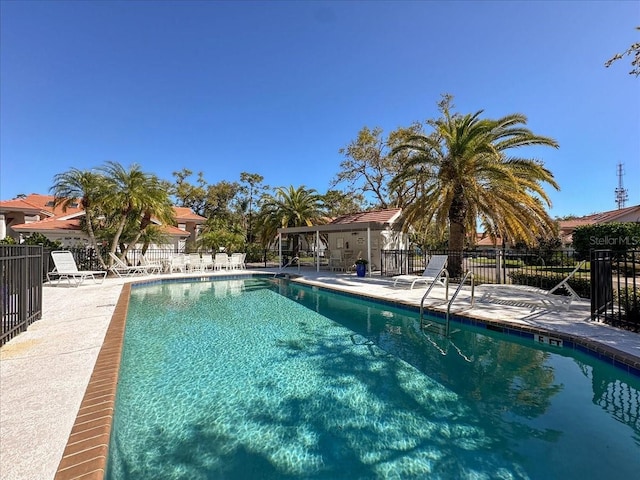 community pool featuring a patio and fence