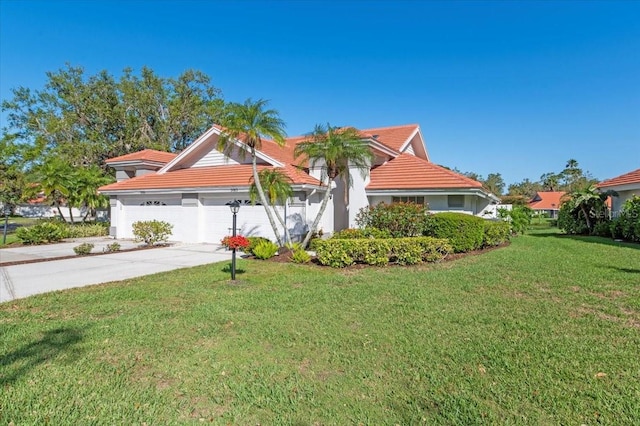 view of front facade with a garage, concrete driveway, a front yard, and a tile roof