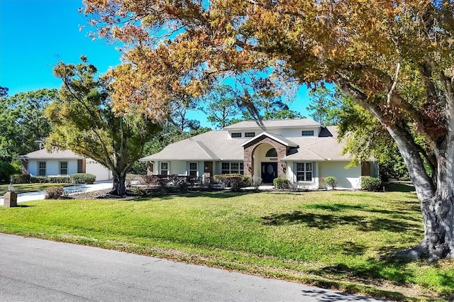 traditional home with a garage and a front yard