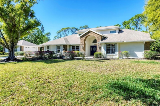 ranch-style home with a front lawn and stucco siding