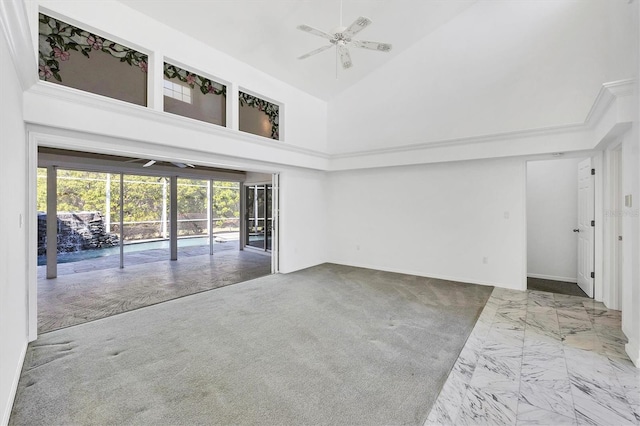 carpeted spare room with high vaulted ceiling and a ceiling fan