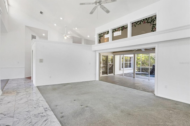 unfurnished living room with visible vents, ceiling fan, recessed lighting, marble finish floor, and high vaulted ceiling