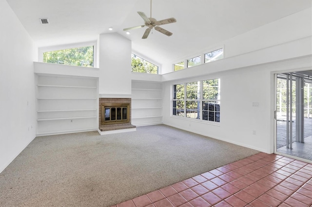 unfurnished living room featuring carpet flooring, a healthy amount of sunlight, visible vents, and built in features