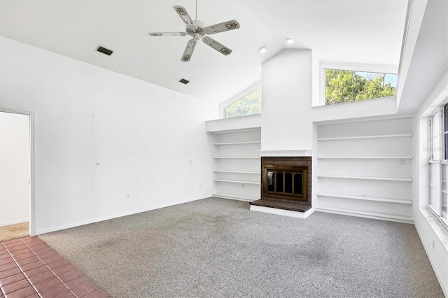 unfurnished living room with visible vents, a brick fireplace, ceiling fan, built in features, and high vaulted ceiling