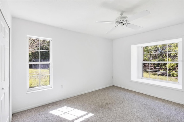 spare room featuring baseboards, carpet floors, and a healthy amount of sunlight