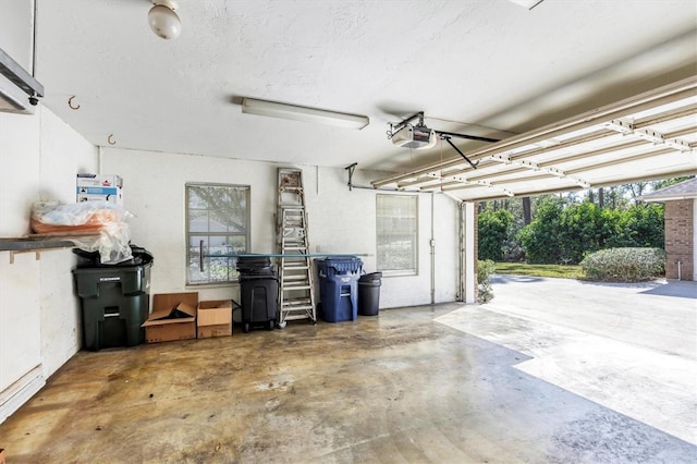 garage with a baseboard radiator and a garage door opener